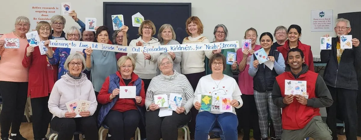 Volunteers holding handmade cards, spreading kindness for NoahStrong