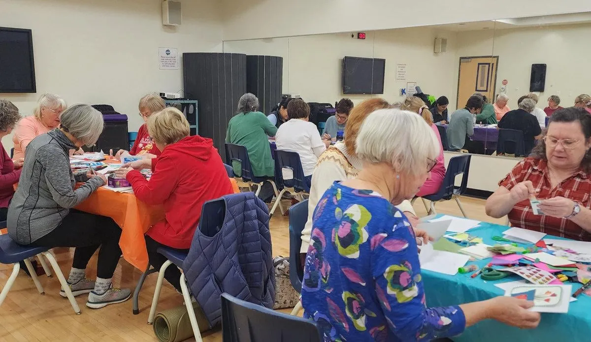 Seniors making cards together at a community kindness event