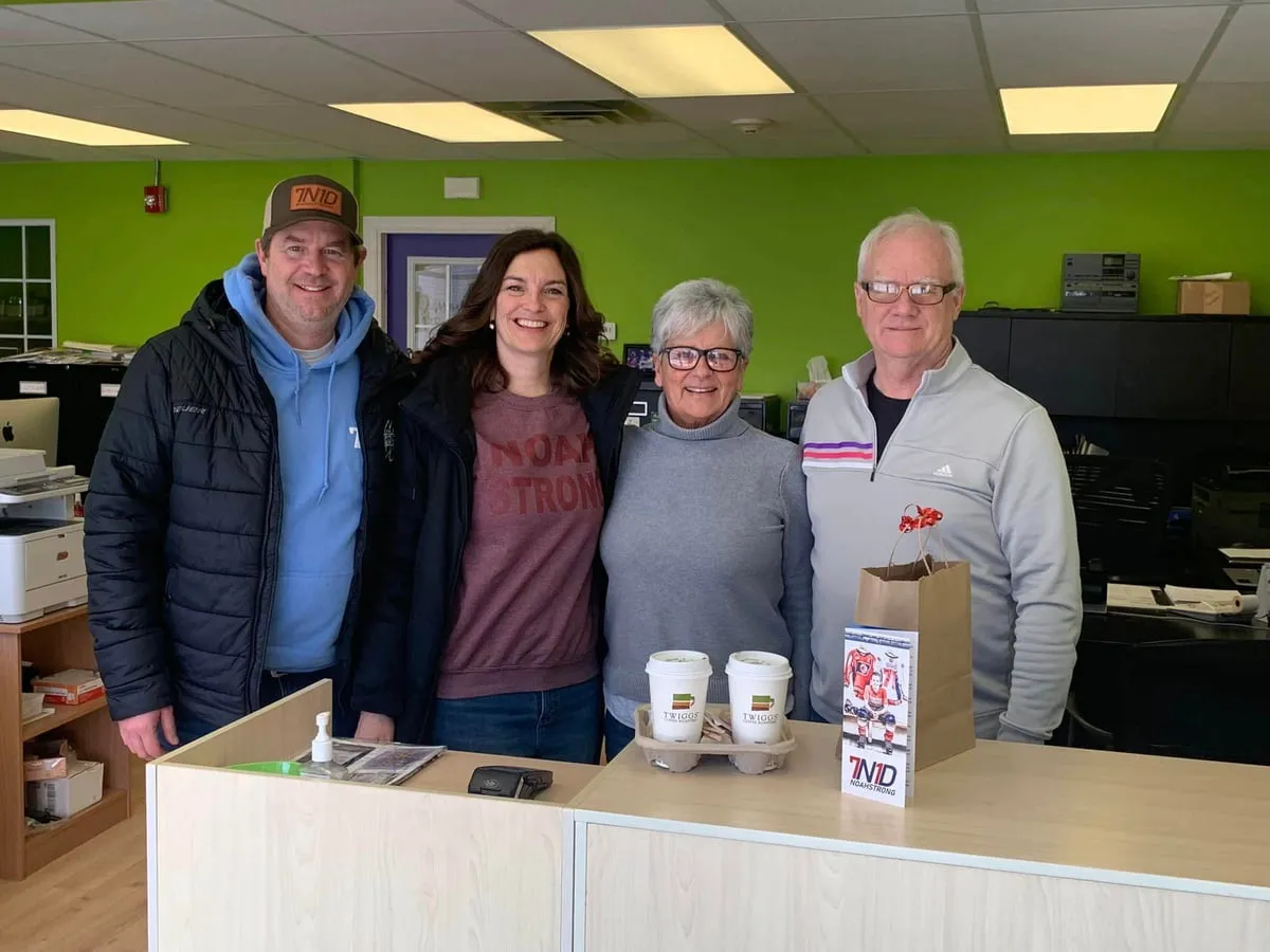 Supporters with NoahStrong coffee and cards at a front desk