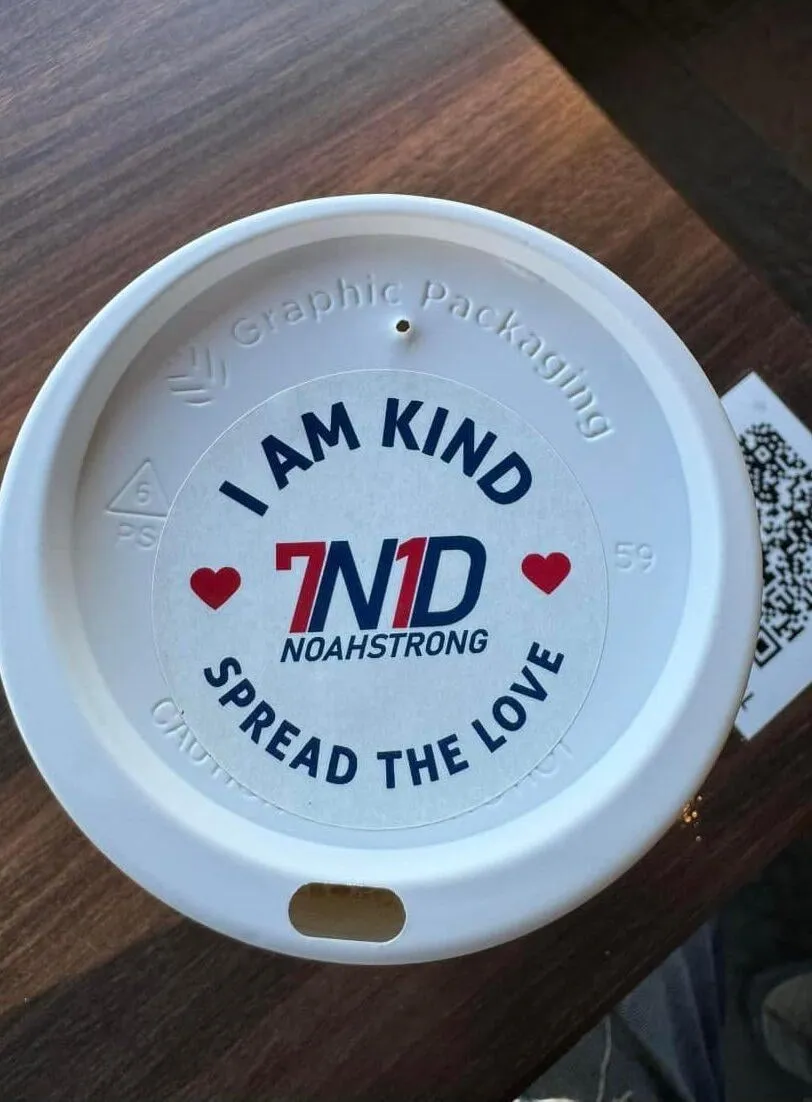 Coffee cup lid printed with I am kind, 7N1D NoahStrong, spread the love