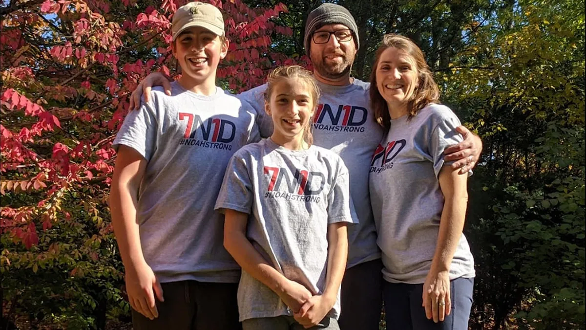 Family of four wearing 7N1D tee shirts